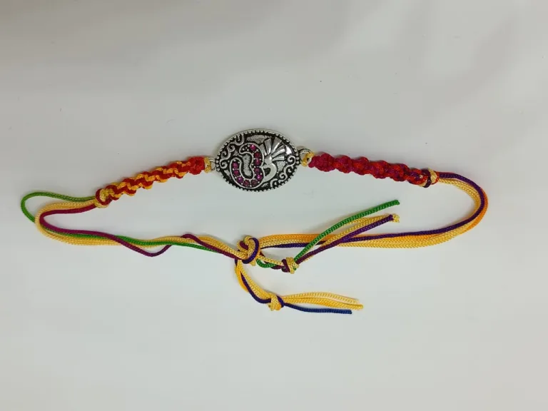 Om designed pure silver rakhi