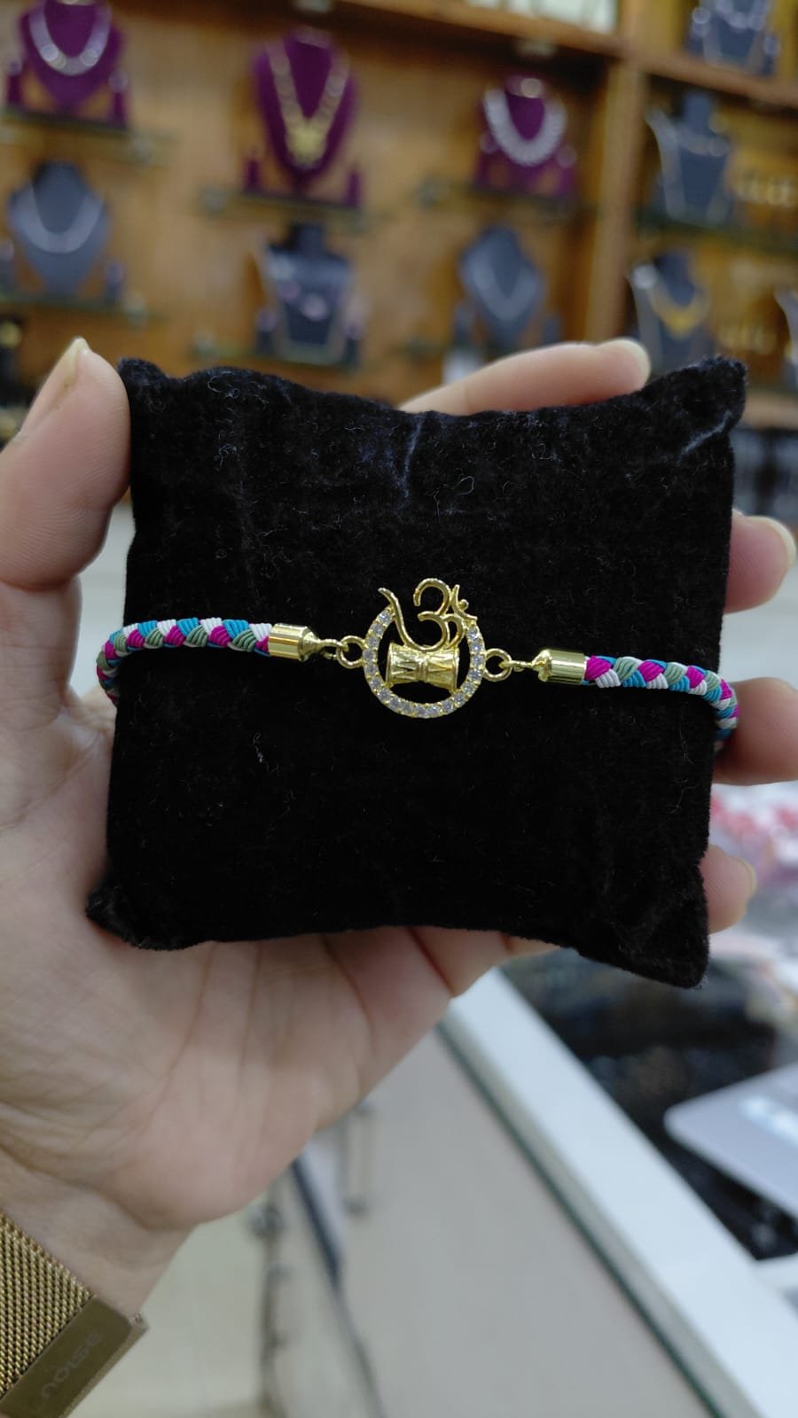 silver om rakhi
